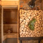 Interior of a wooden russian sauna with traditional items for use.