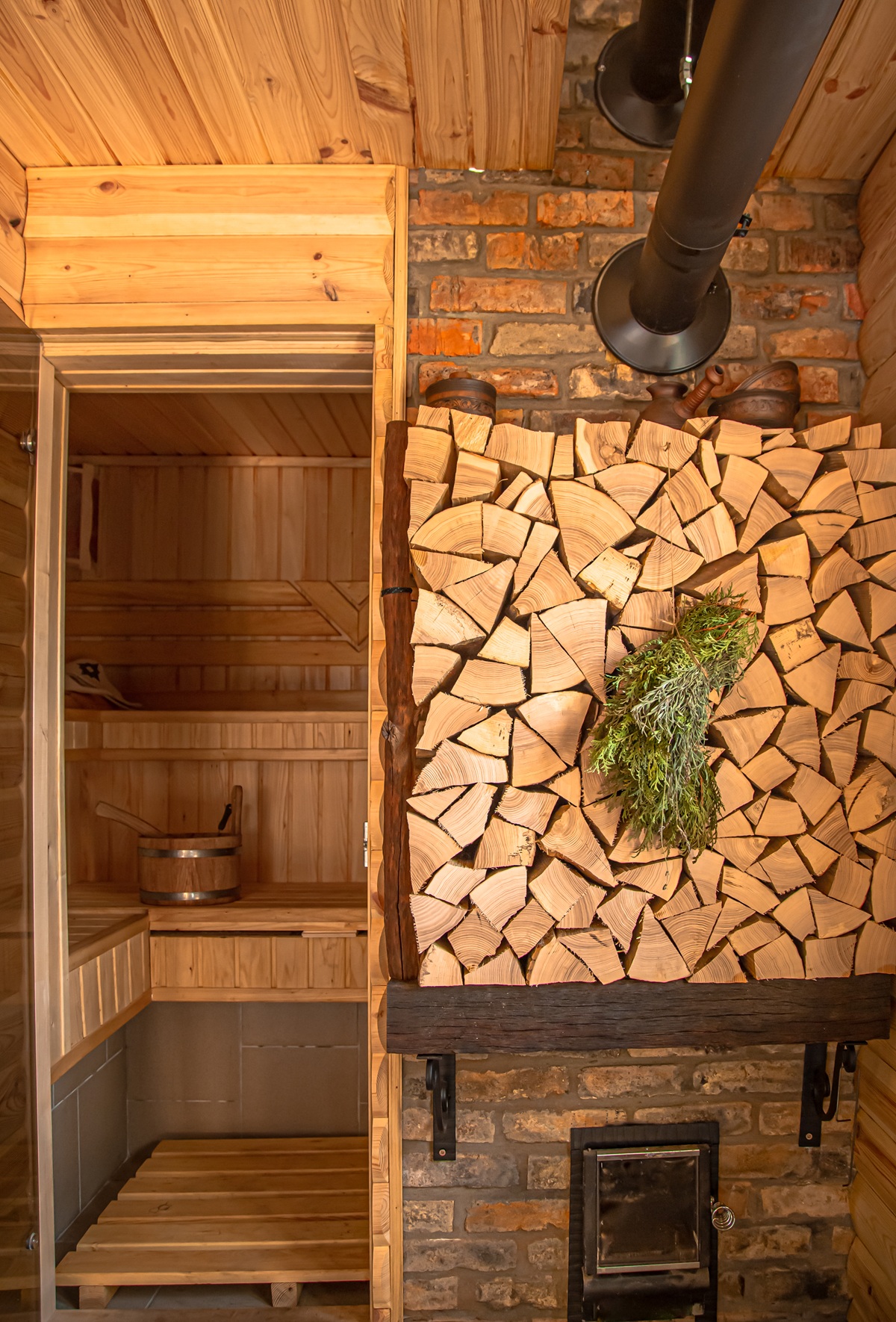 Interior of a wooden russian sauna with traditional items for use.